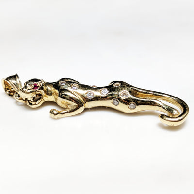 A gold panther pendant by Lucky Diamond. The individual spots have been accentuated by cubic zirconia.